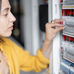Homeowner checking circuit breaker panel
